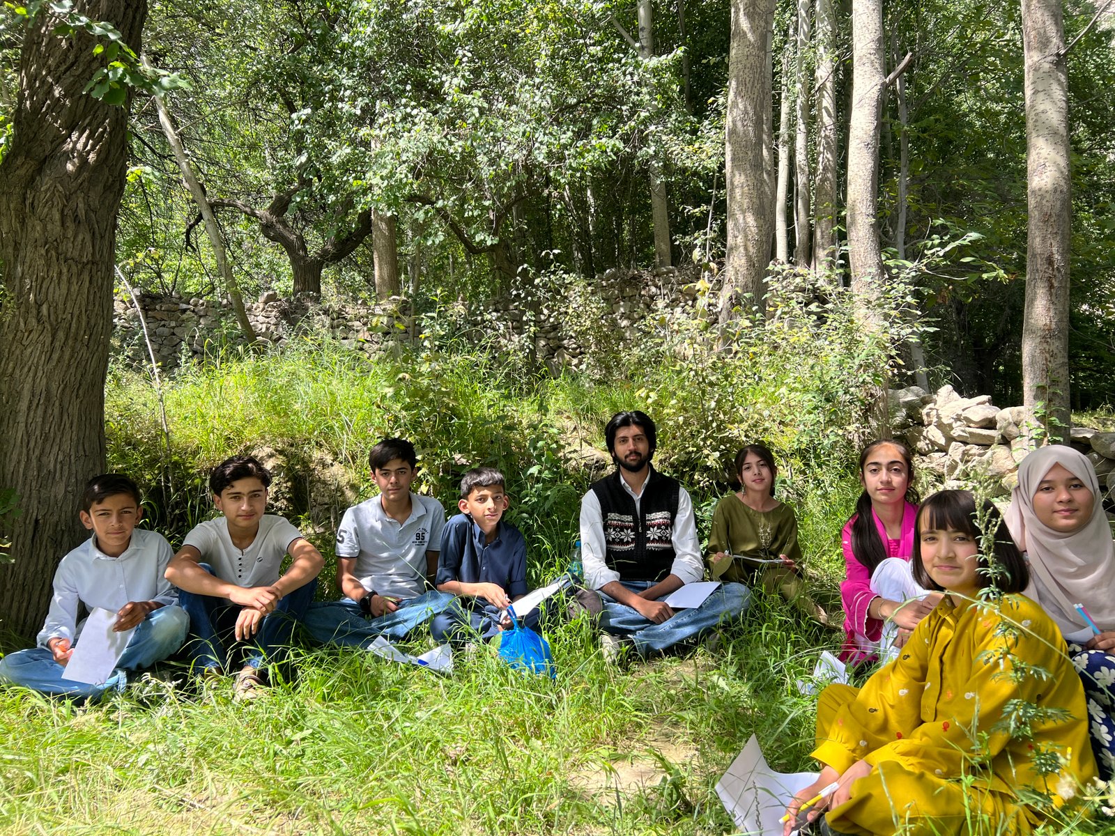 E47 Ventures students gathered outdoors during a class session in Hunza.